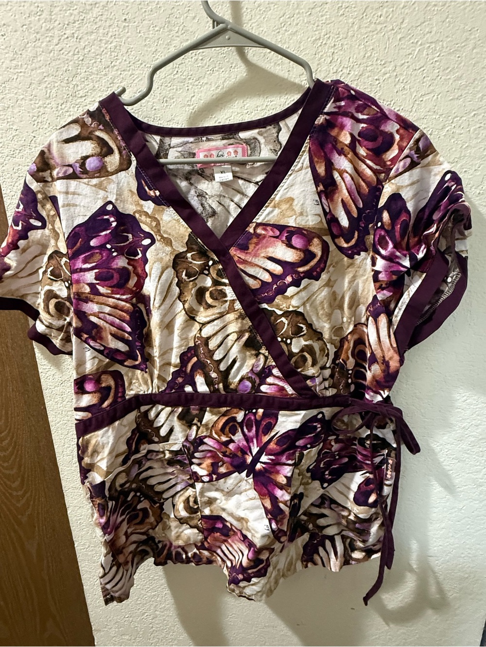 koi Butterfly Wrap-Style Tunic scrub top in Purple and Cream